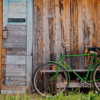 Old wooden wall and green bicycle
